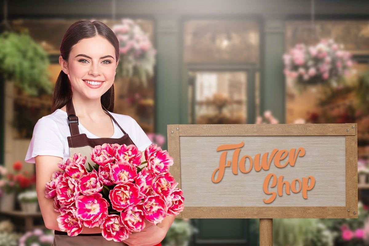 Flower shop owner holding a bouquet next to a sign that reads "Flower shop"