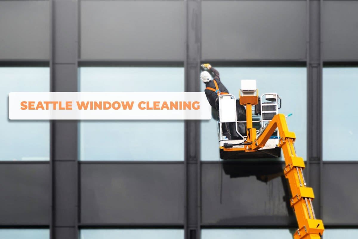 Window cleaner on a lift working on high rise windows with a search bar that reads "Seattle Window Cleaning" hovering in the foreground
