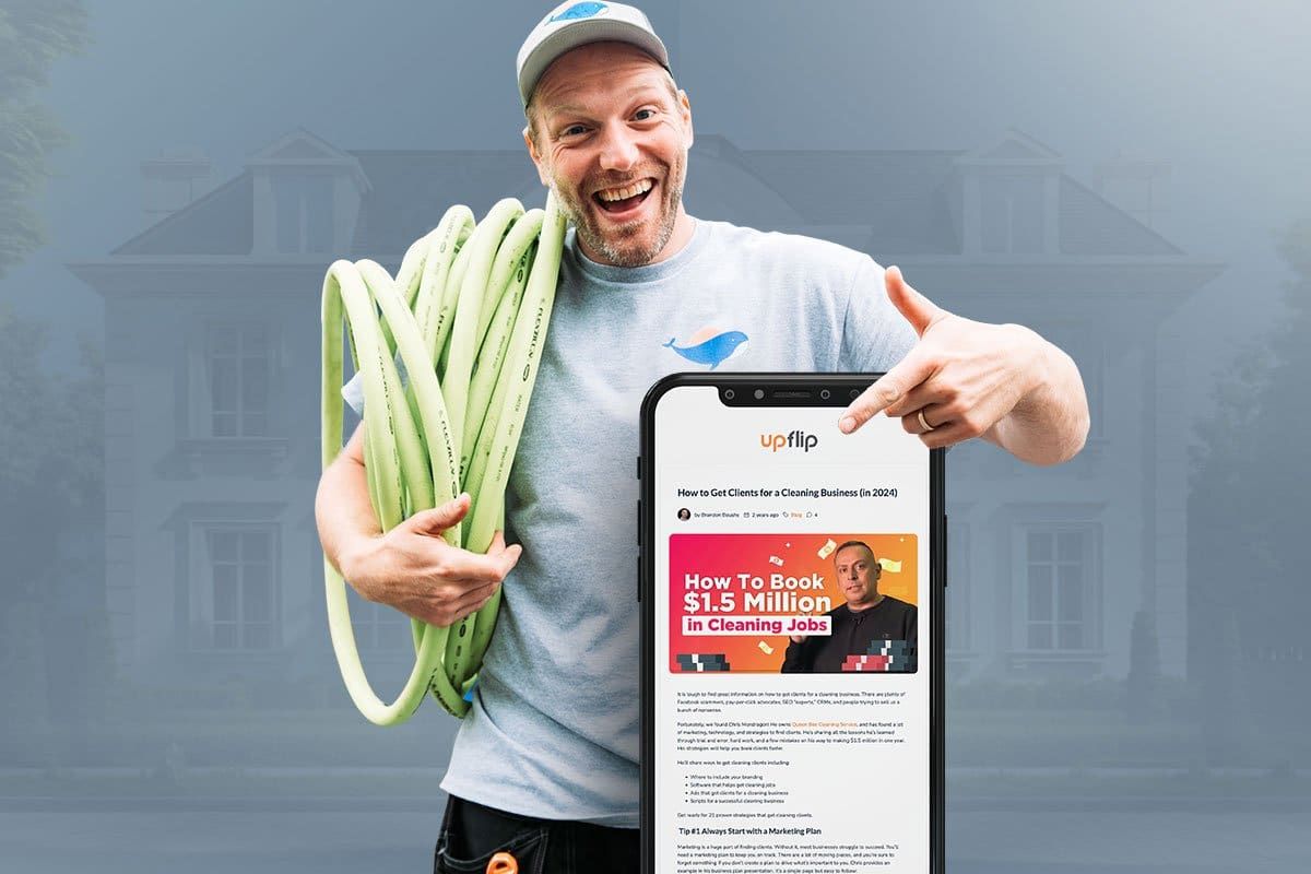 Martin Skarra standing in front of a large residence with a lime green hose over his shoulder pointing to a smart phone showing UpFlip’s How to Get Clients for a Cleaning Business blog post